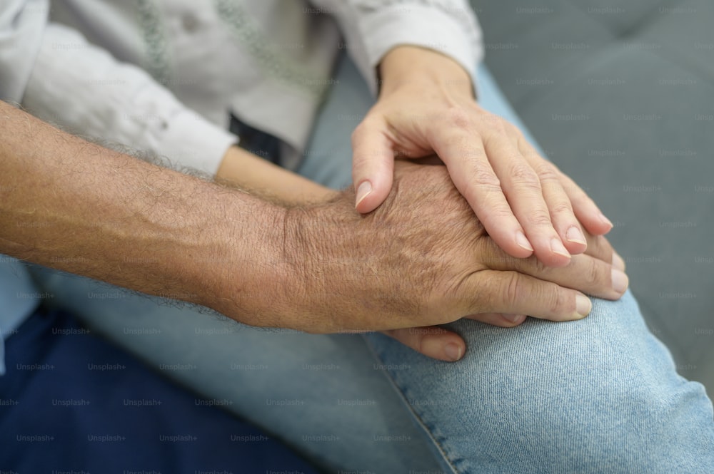 Close up of elderly hands holding each other , Grandfather hands is holding grandma hands , together , family concept