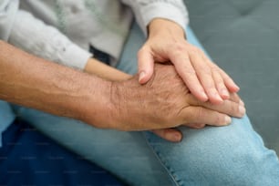 Close up of elderly hands holding each other , Grandfather hands is holding grandma hands , together , family concept