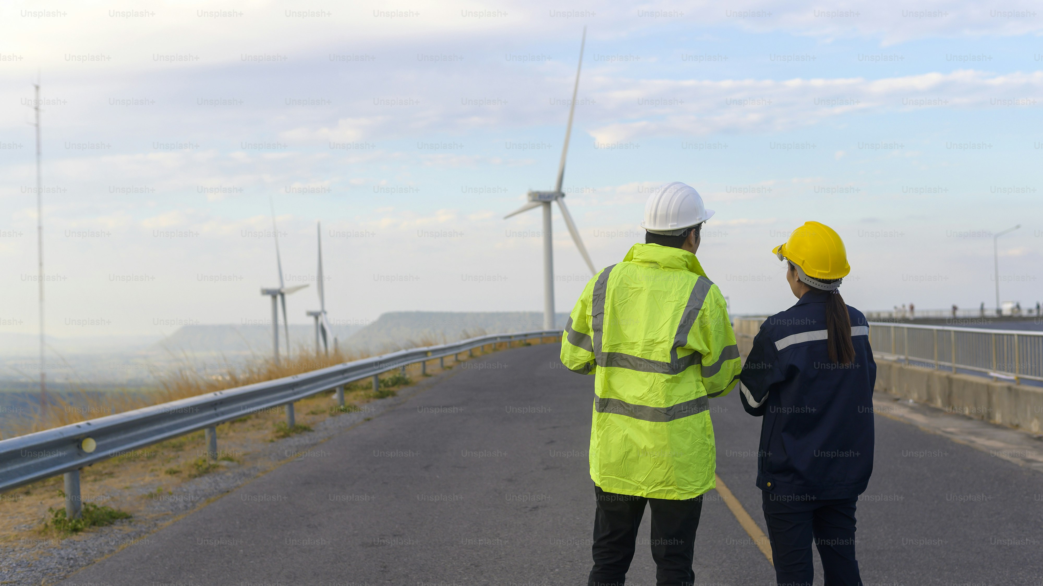 people engineer are wearing a protective helmet on head, using tablet Analytics engineering data.
