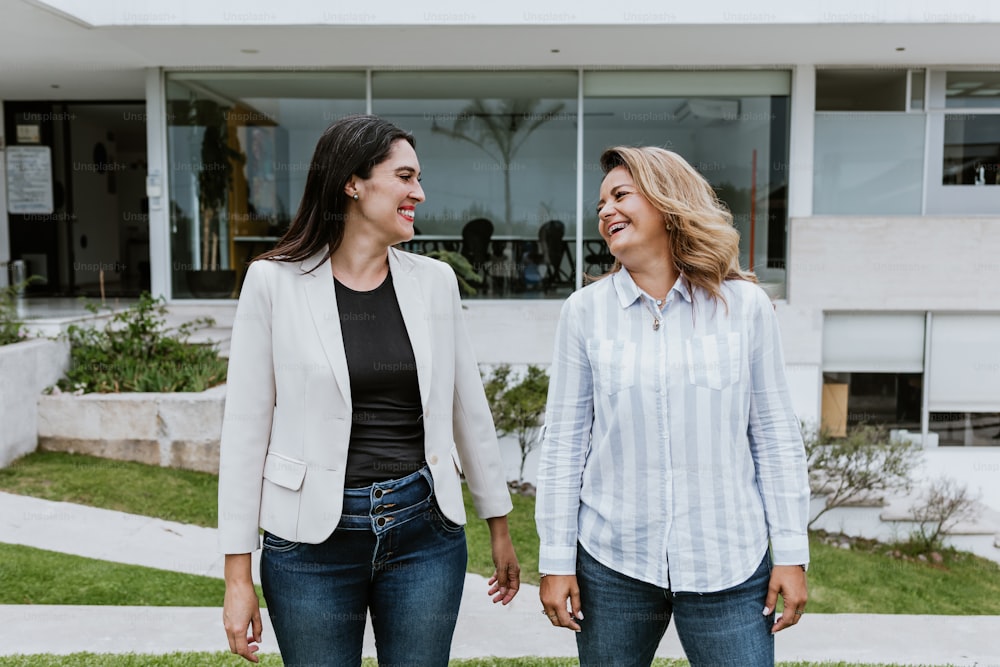 two latin women friends having fun at terrace office in Mexico Latin America