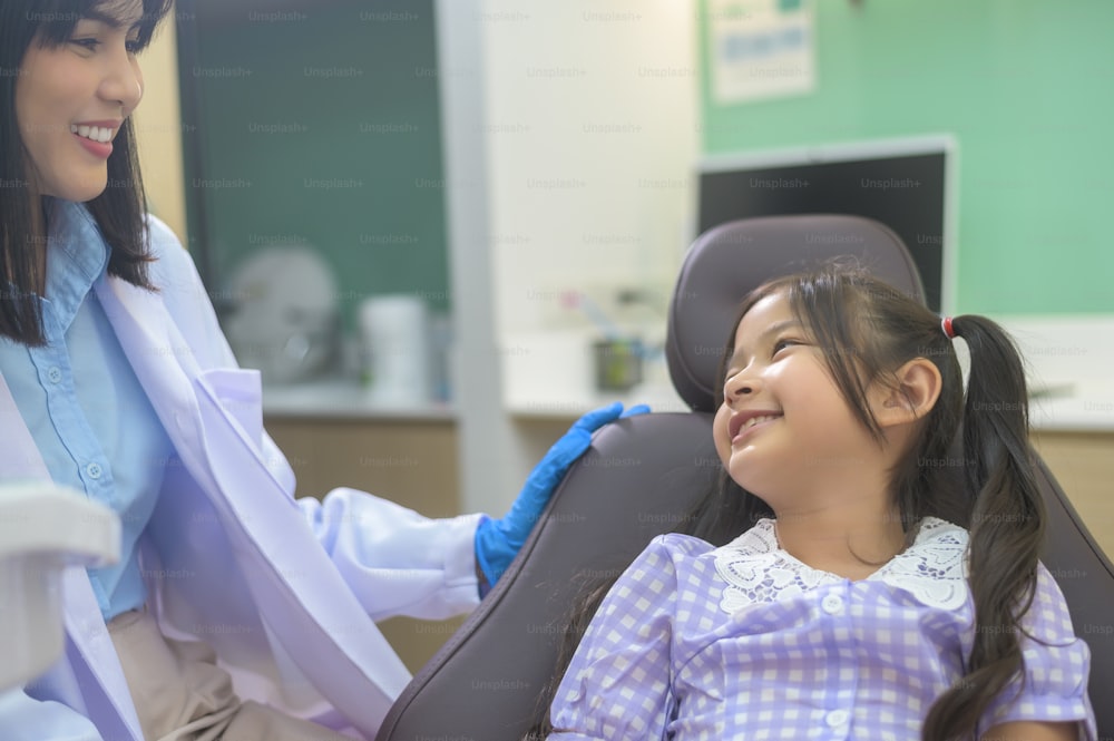 A little cute girl having teeth examined by dentist in dental clinic, teeth check-up and Healthy teeth concept