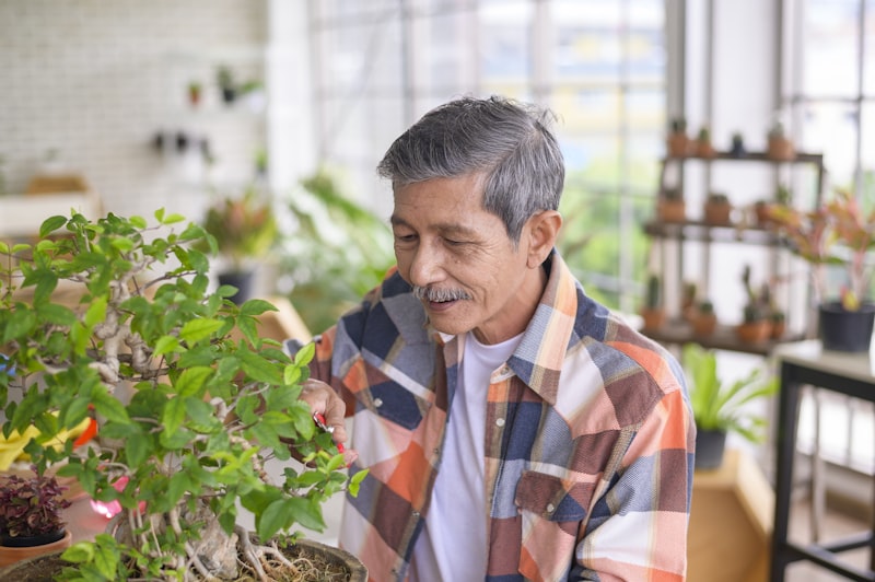 Happy senior asian retired man  is relaxing  and enjoying  leisure activity in garden at home.
