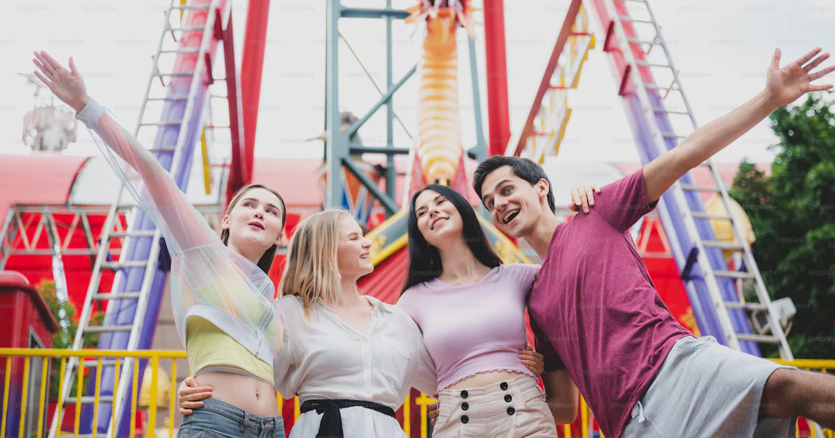 Group Fun Website Group of friends having fun and relaxing at an amusement theme park ...