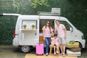 a joyful Asian family enjoying road trip and journey is going on holiday, travel and tourism concept