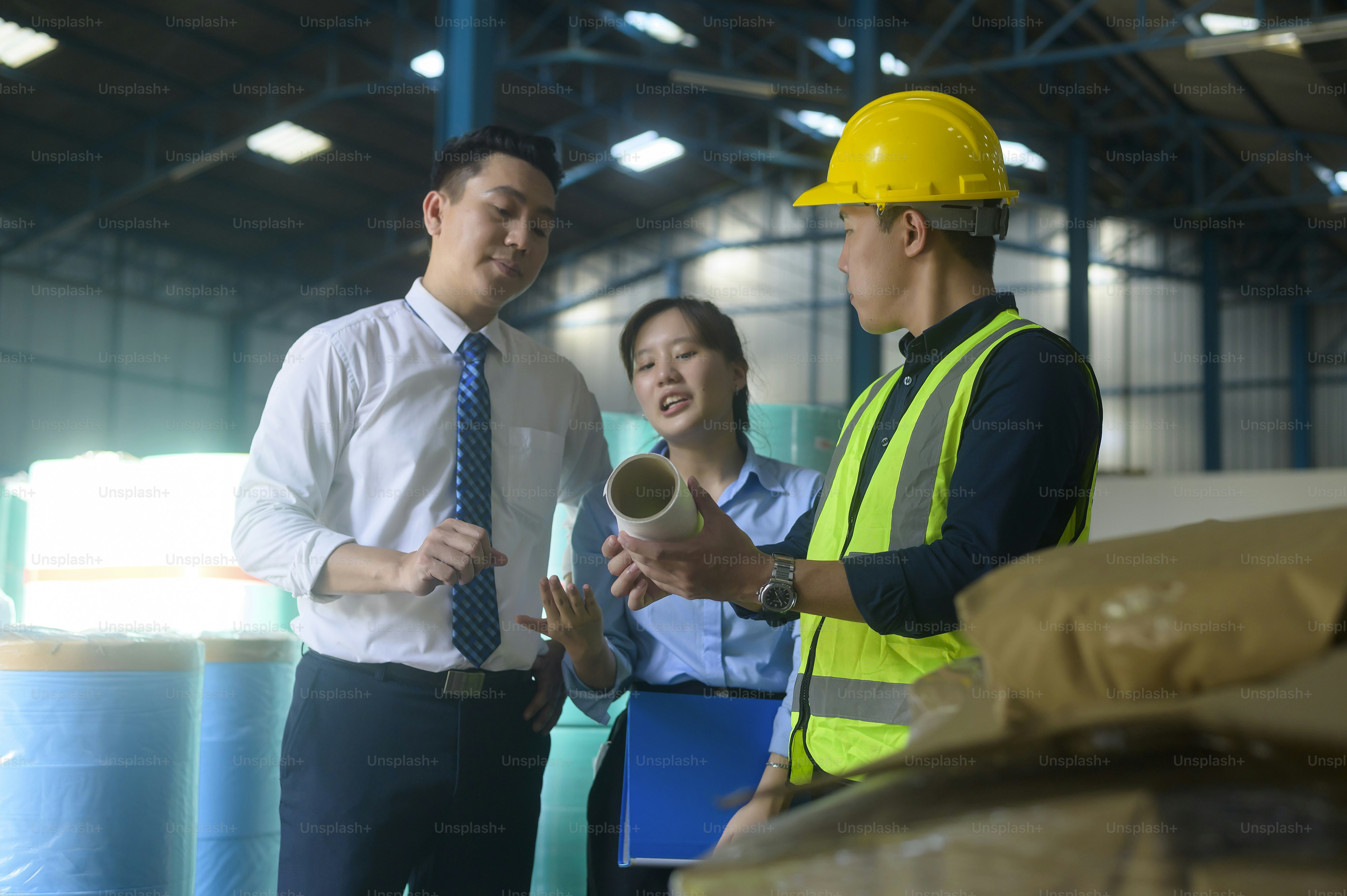Thai factory workers reviewing SOPs