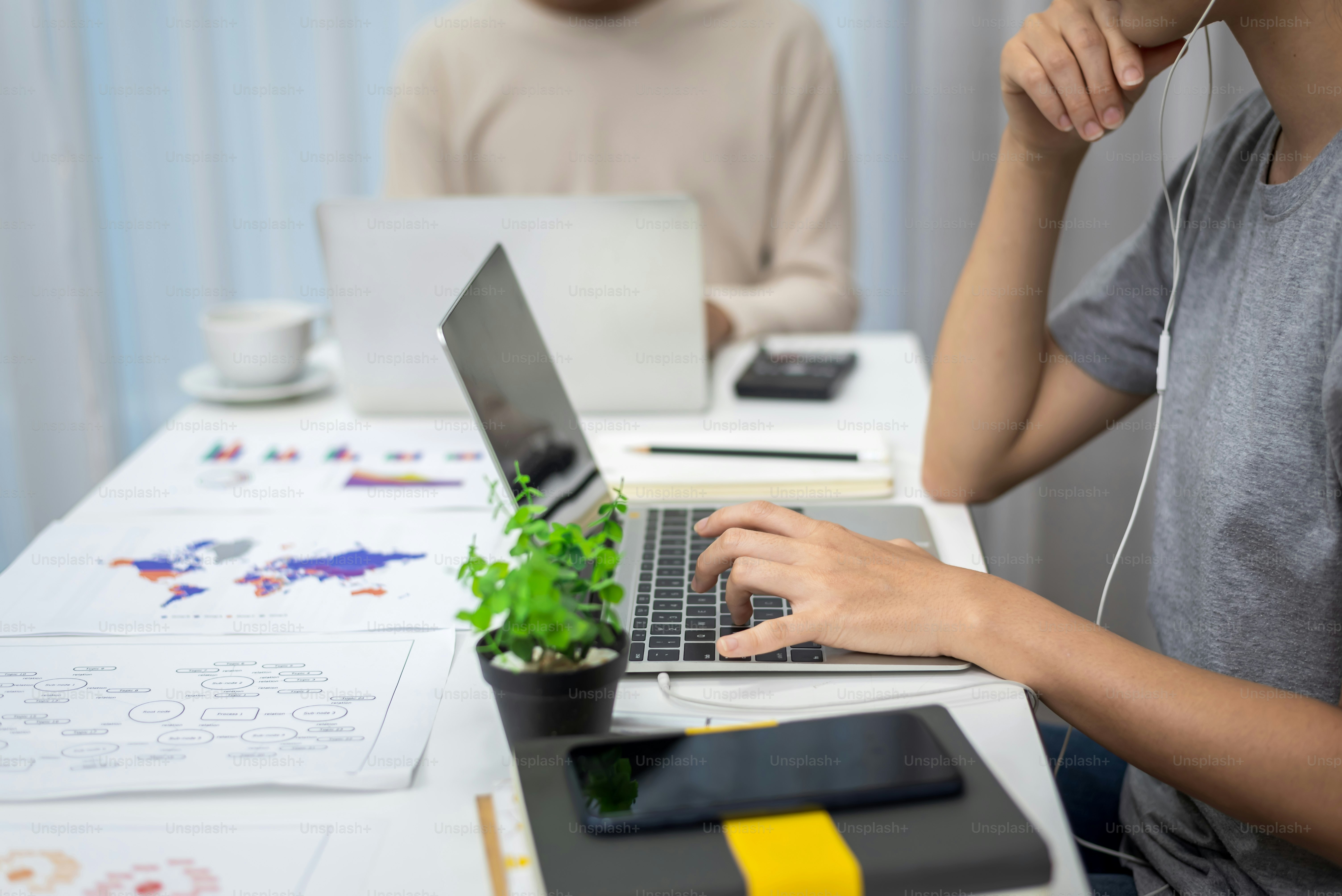 Two office workers work at home in casual clothes during COVID infection prevention.