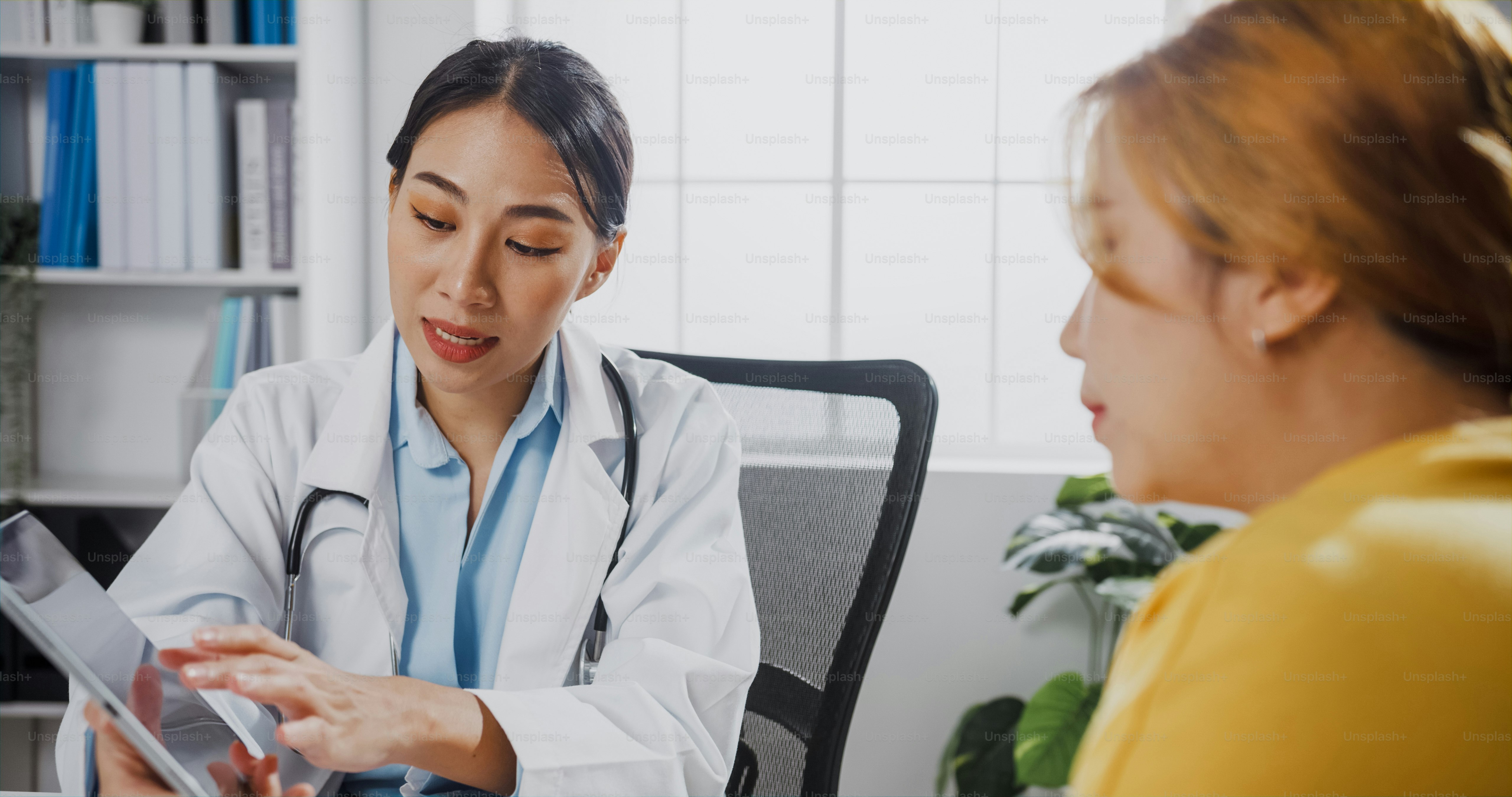 A caring conversation between a health worker and a woman in a bright clinic.