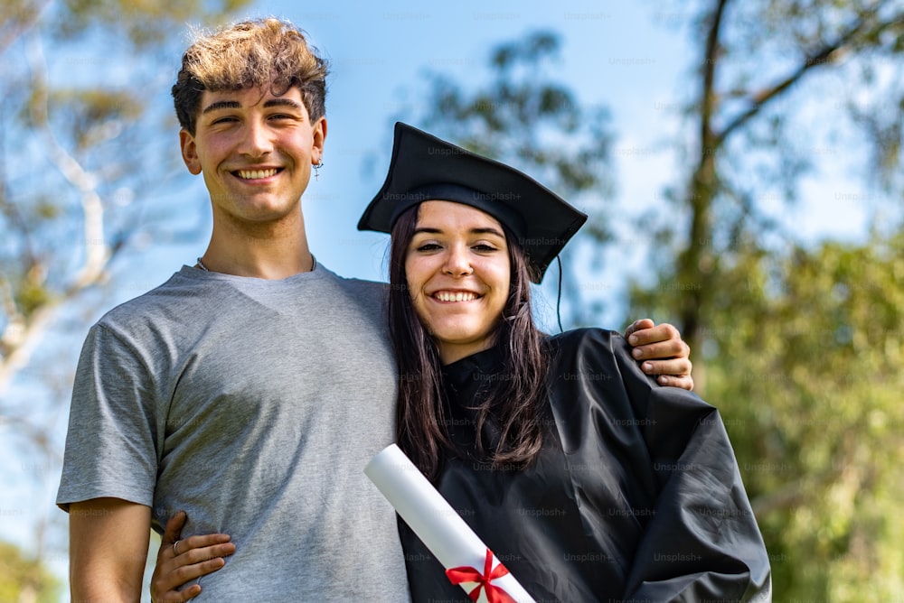 Happy caucasian graduated girl with her boyfriend or her brother on her graduation Day