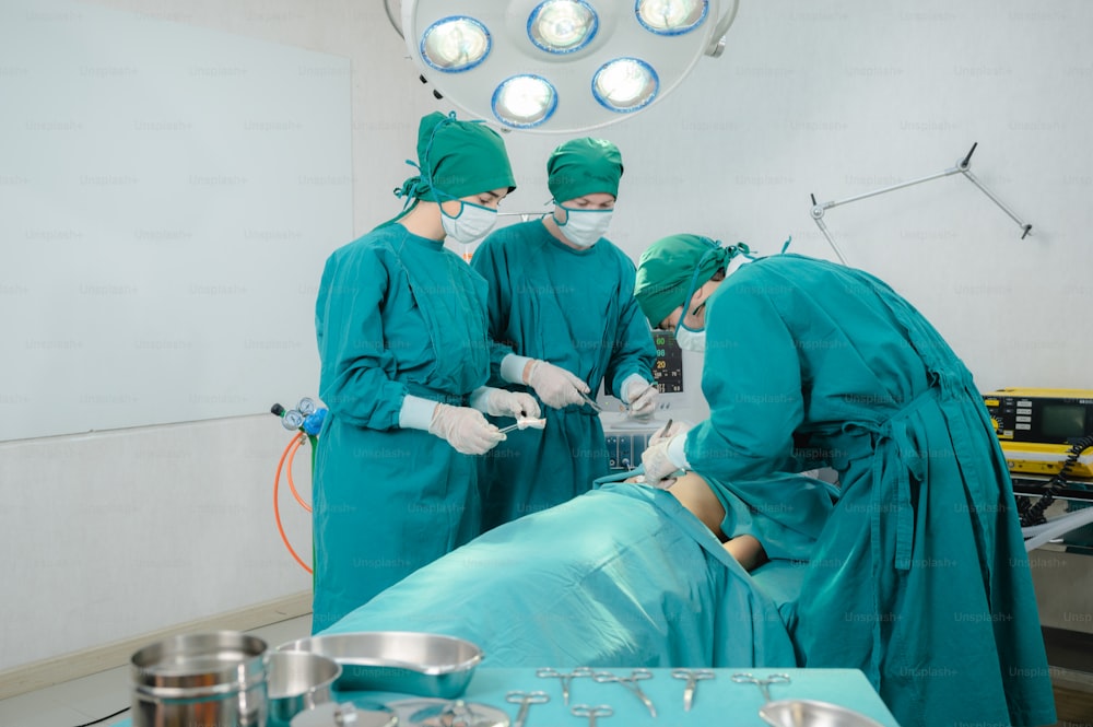 professional surgeon doctor teamwork person working in hospital operation room with surgery medical health equipment with surgical patient and nurse, emergency medicine treatment clinic concept