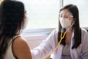 health insurance concept, young Asian woman professional doctor are checking her patient in hospital, medical heal care consultation