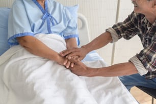 A Senior man visiting senior patient woman at hospital, health care and medical concept