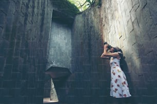 Young girl traveler sitting on circle stairs of a spiral staircase, Singapore