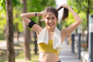 sport asian female teen portrait shot while morning running jogging healthy routine activity sunnday at public park,asia woman wear sport wear smile look at camera while take a break from run exercise