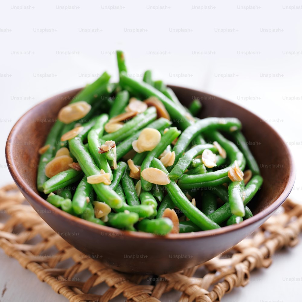 close up photo of a bowl of green beans with almonds