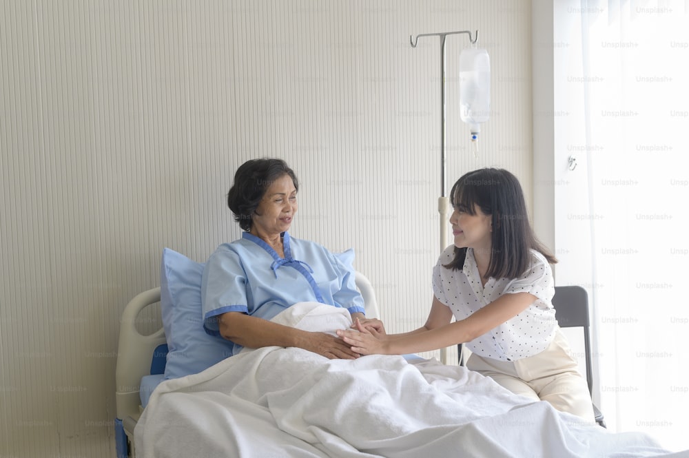 Senior patient woman and her supportive daughter in hospital, health and insurance concept.