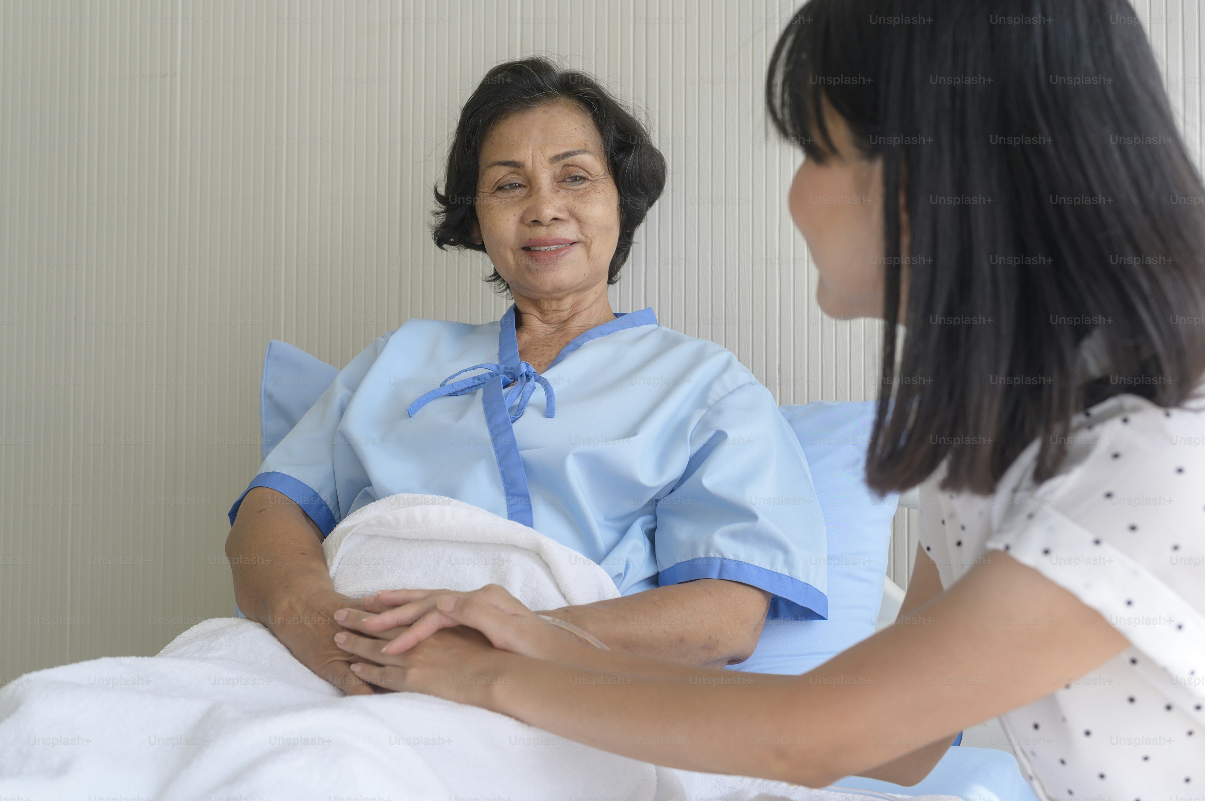 Senior patient woman and her supportive daughter in hospital, health and insurance concept.