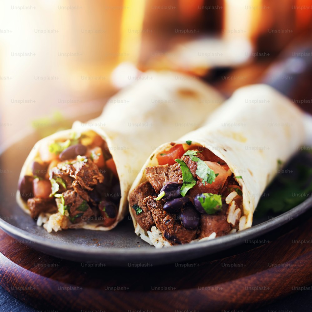 mexican beef steak burritos with black beans, rice, and salsa
