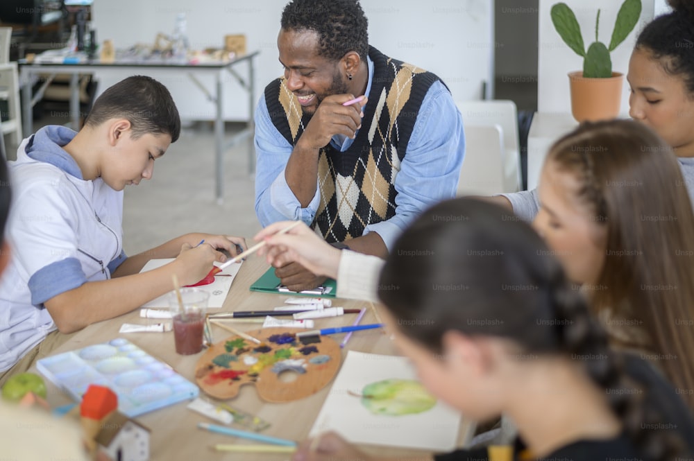 group of students studying and playing with teacher, education and learning concept.