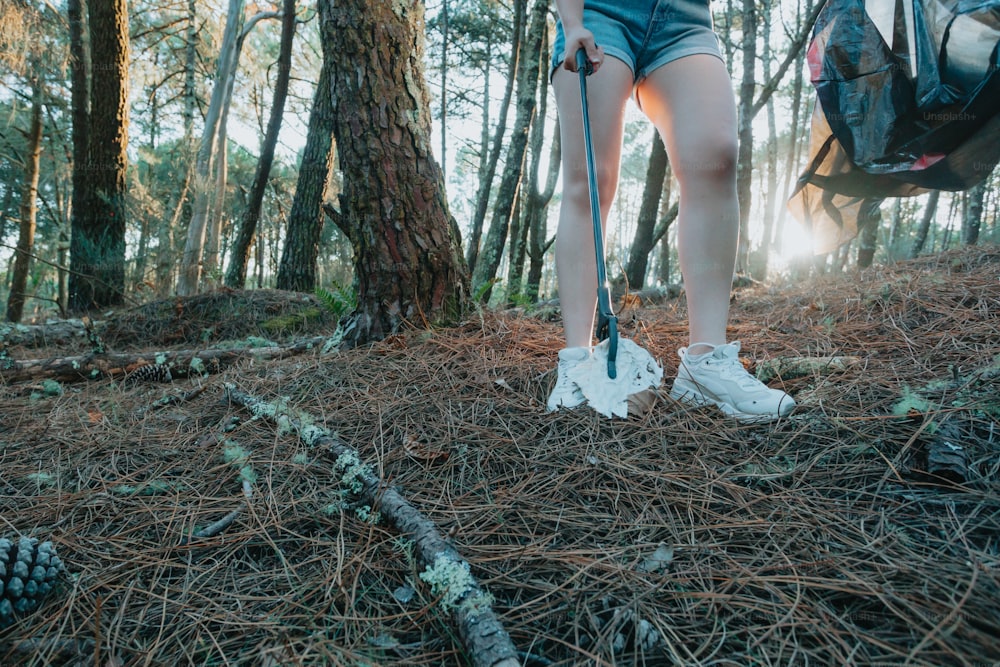 a person standing in the woods with a backpack