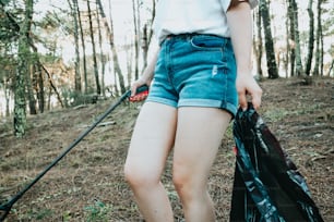 a woman in shorts and a white shirt holding a black bag