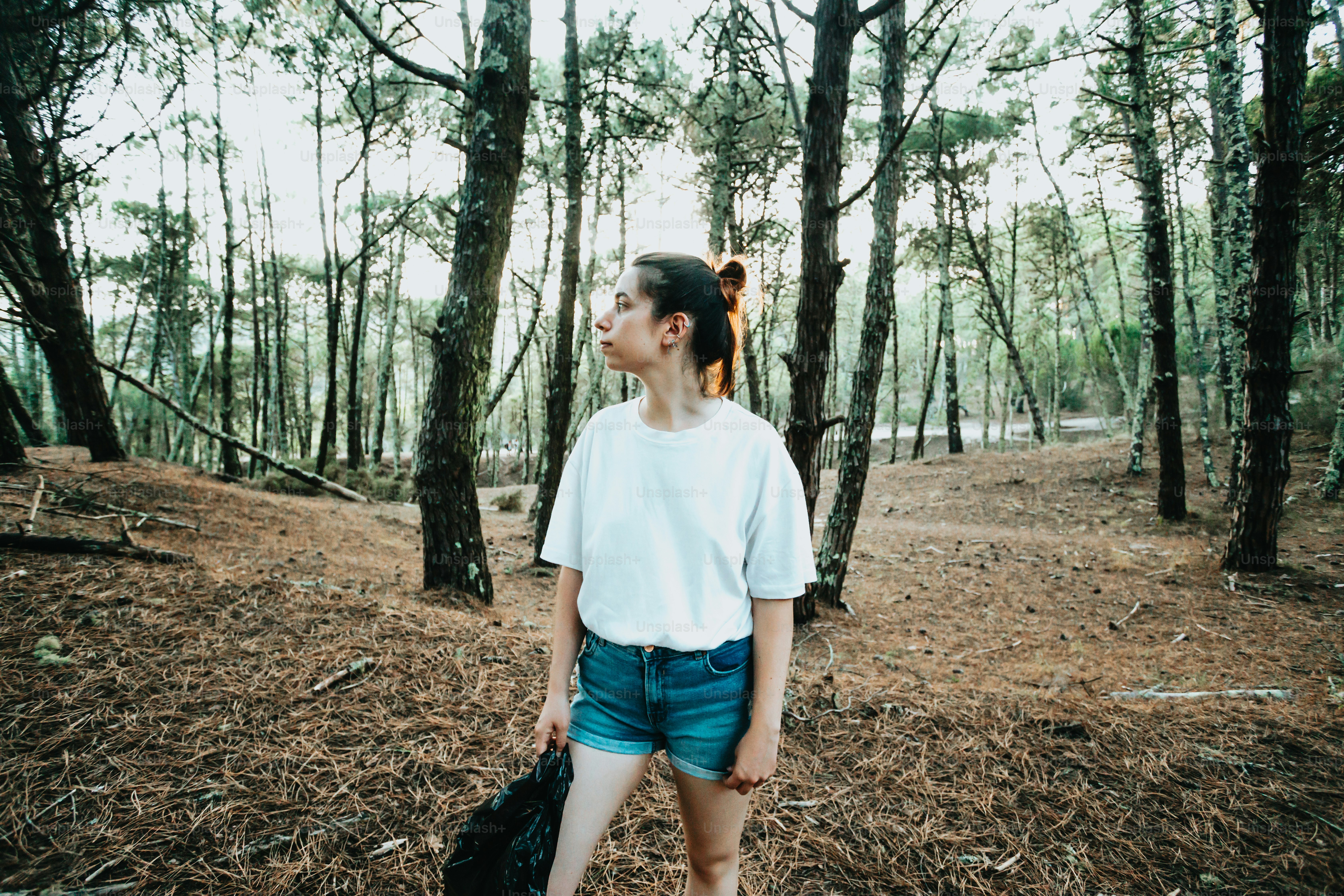 A woman standing in the middle of a forest photo – Girl in the forest ...