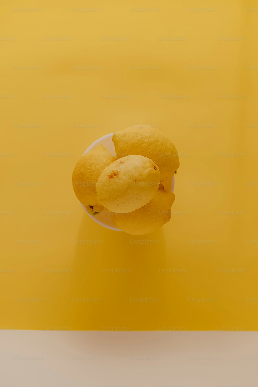 a white plate topped with three pieces of fruit