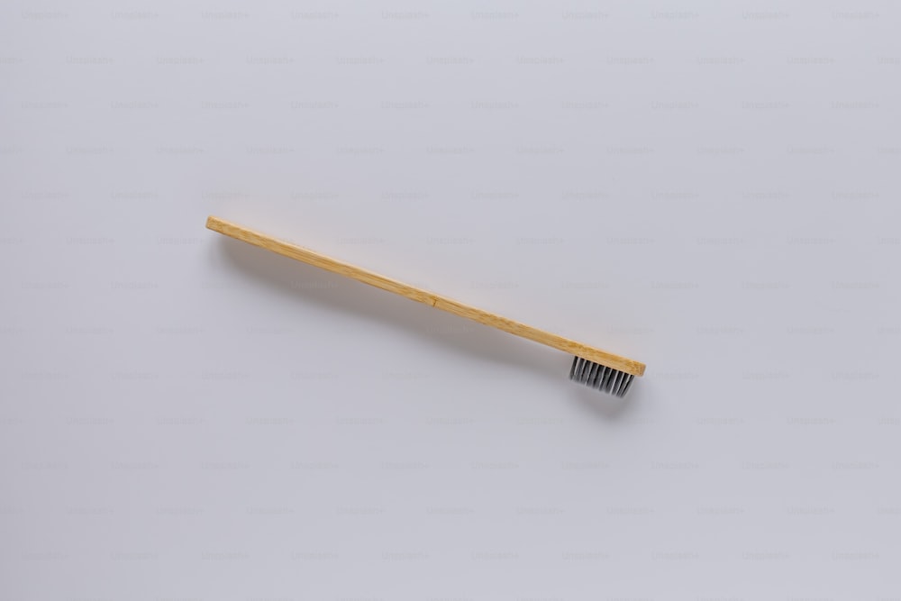 a wooden toothbrush on a white background