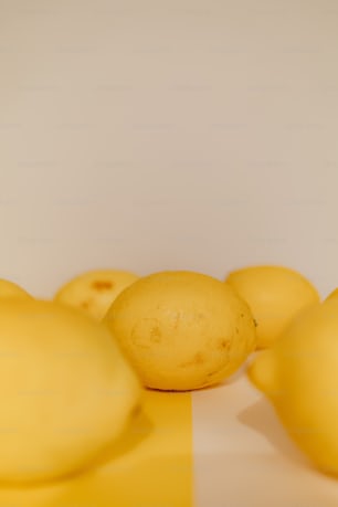a group of lemons sitting on top of a table