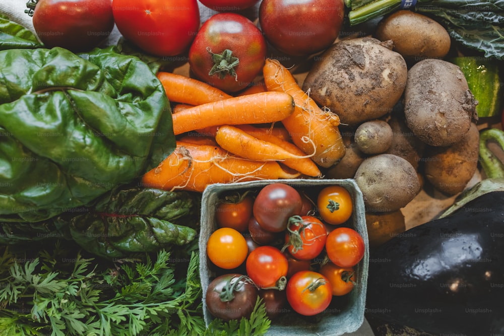 a pile of fresh vegetables sitting on top of a table