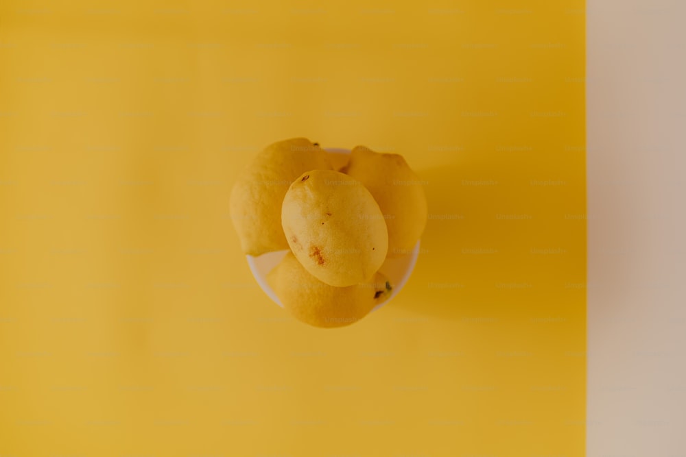 a yellow background with a plate of fruit on it