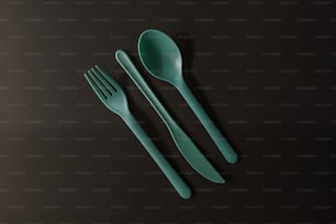 a couple of forks and a spoon on a table