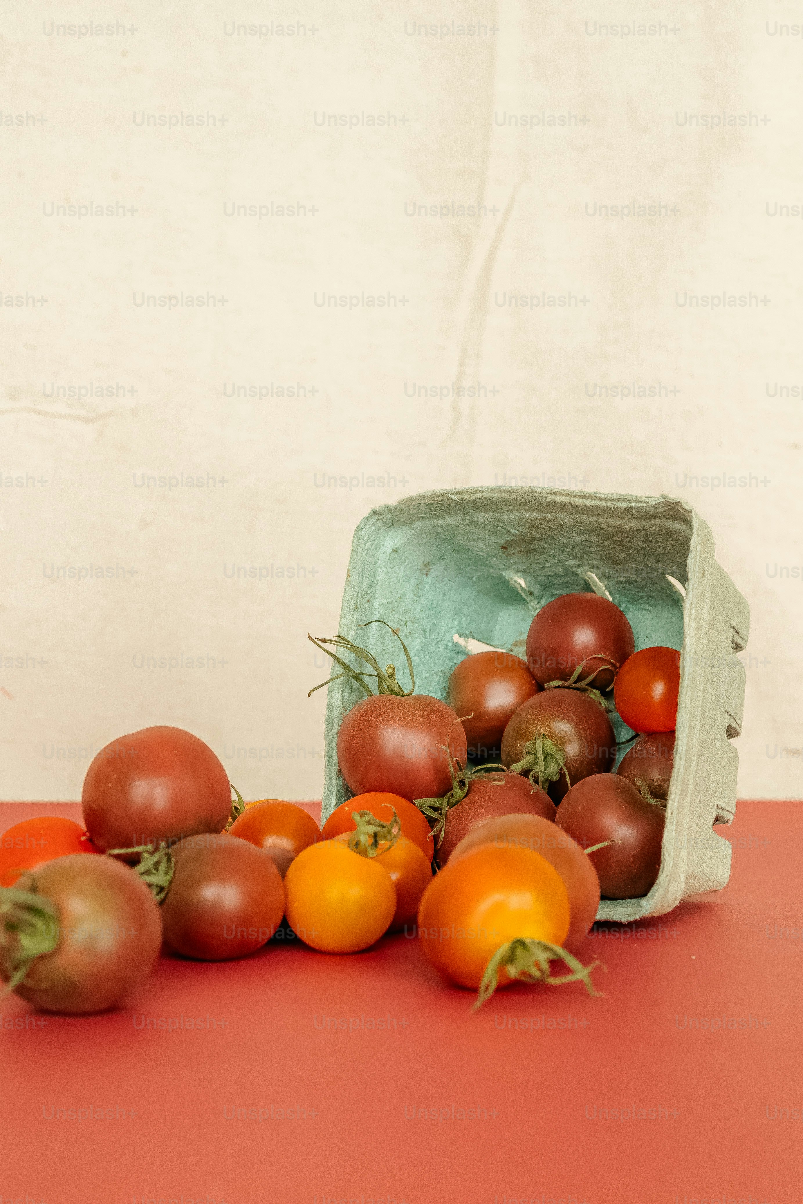 a bunch of tomatoes and other fruits on a table