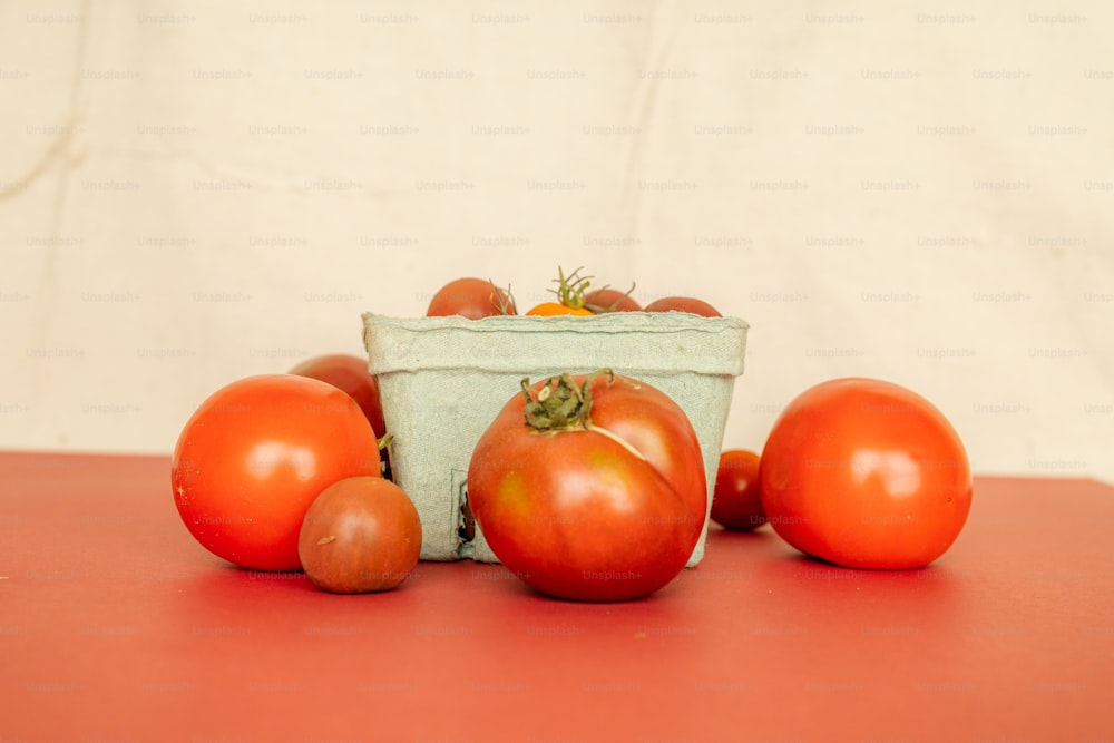 a group of tomatoes sitting on top of a table