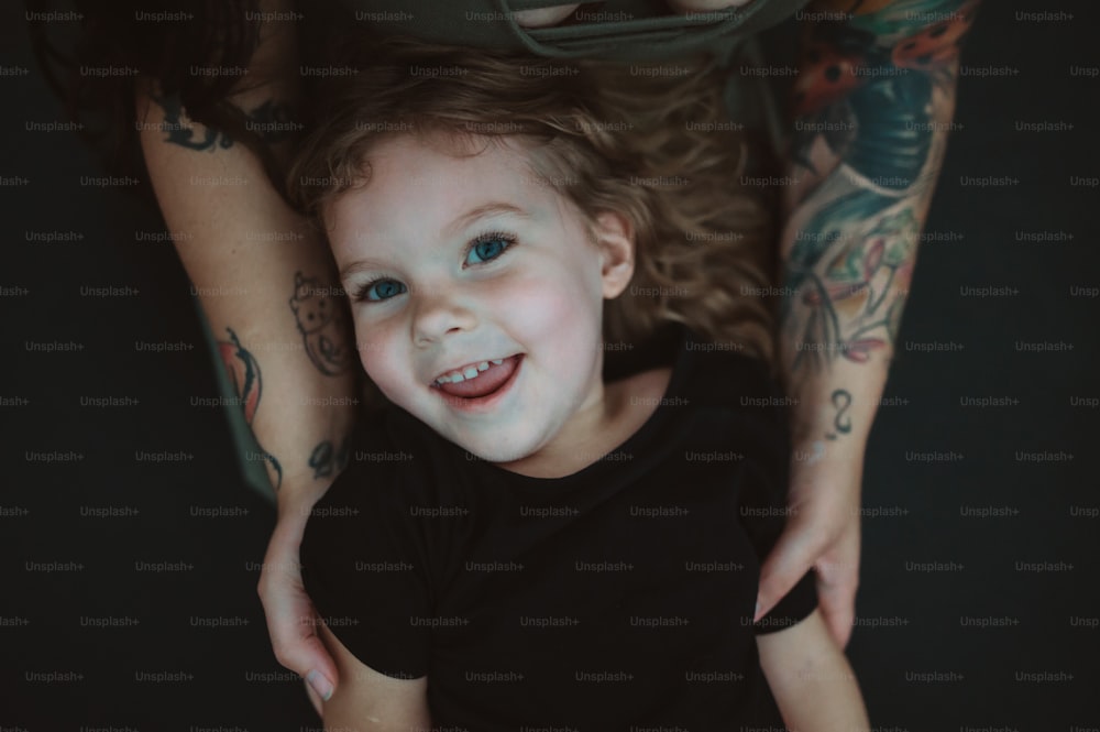 Ein kleines Mädchen mit blauen Augen und einem Lächeln im Gesicht