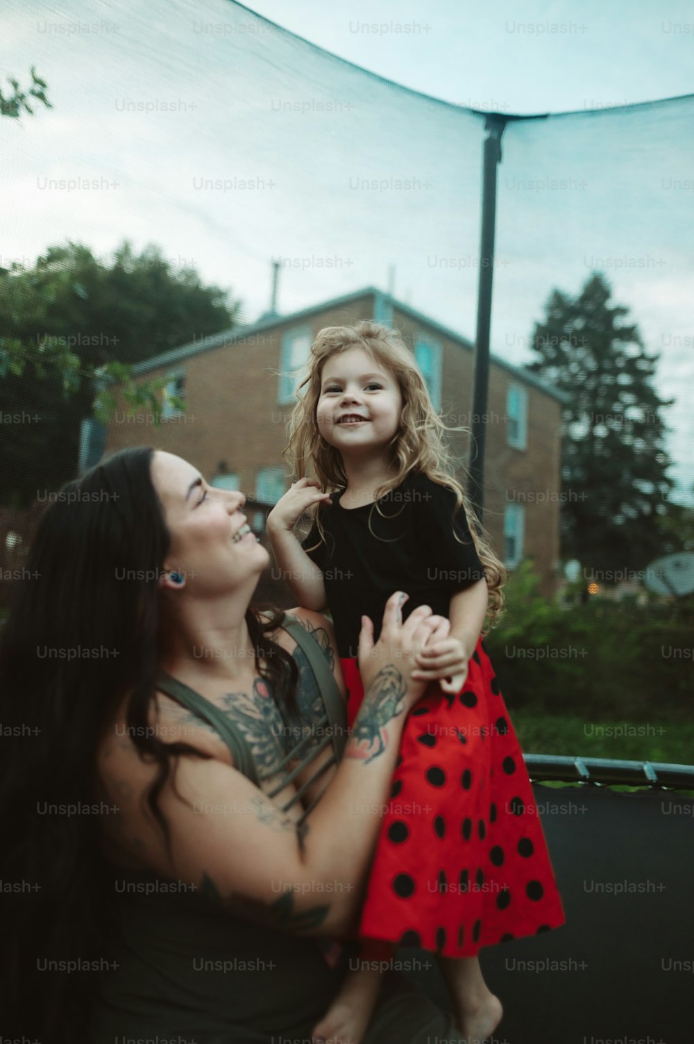 a woman holding a little girl in her arms