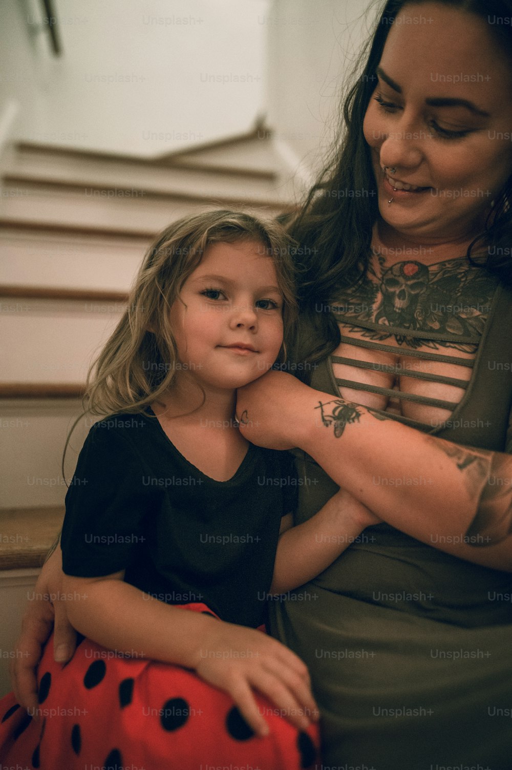 a woman holding a little girl on her lap