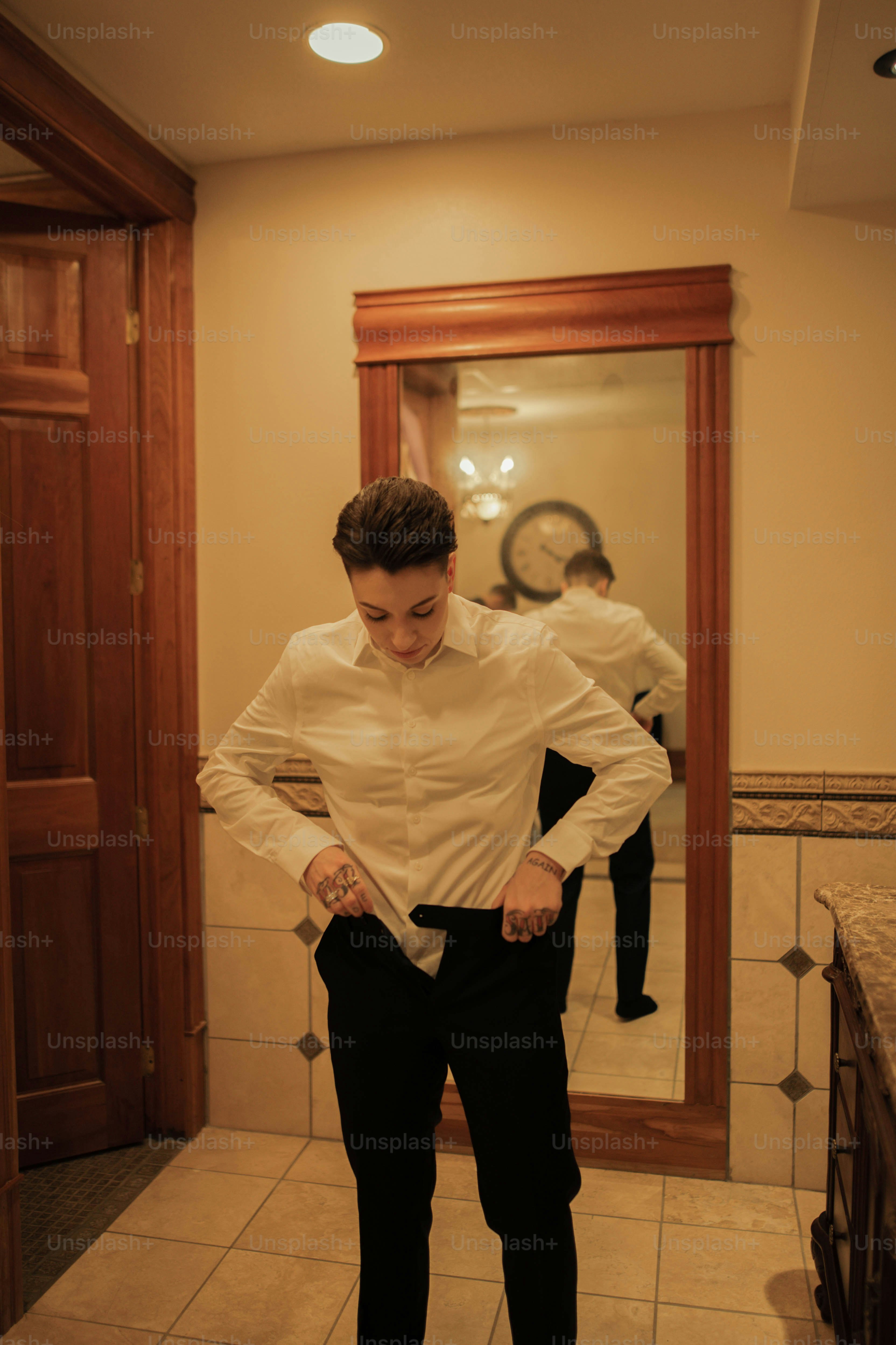a man in a white shirt and black pants