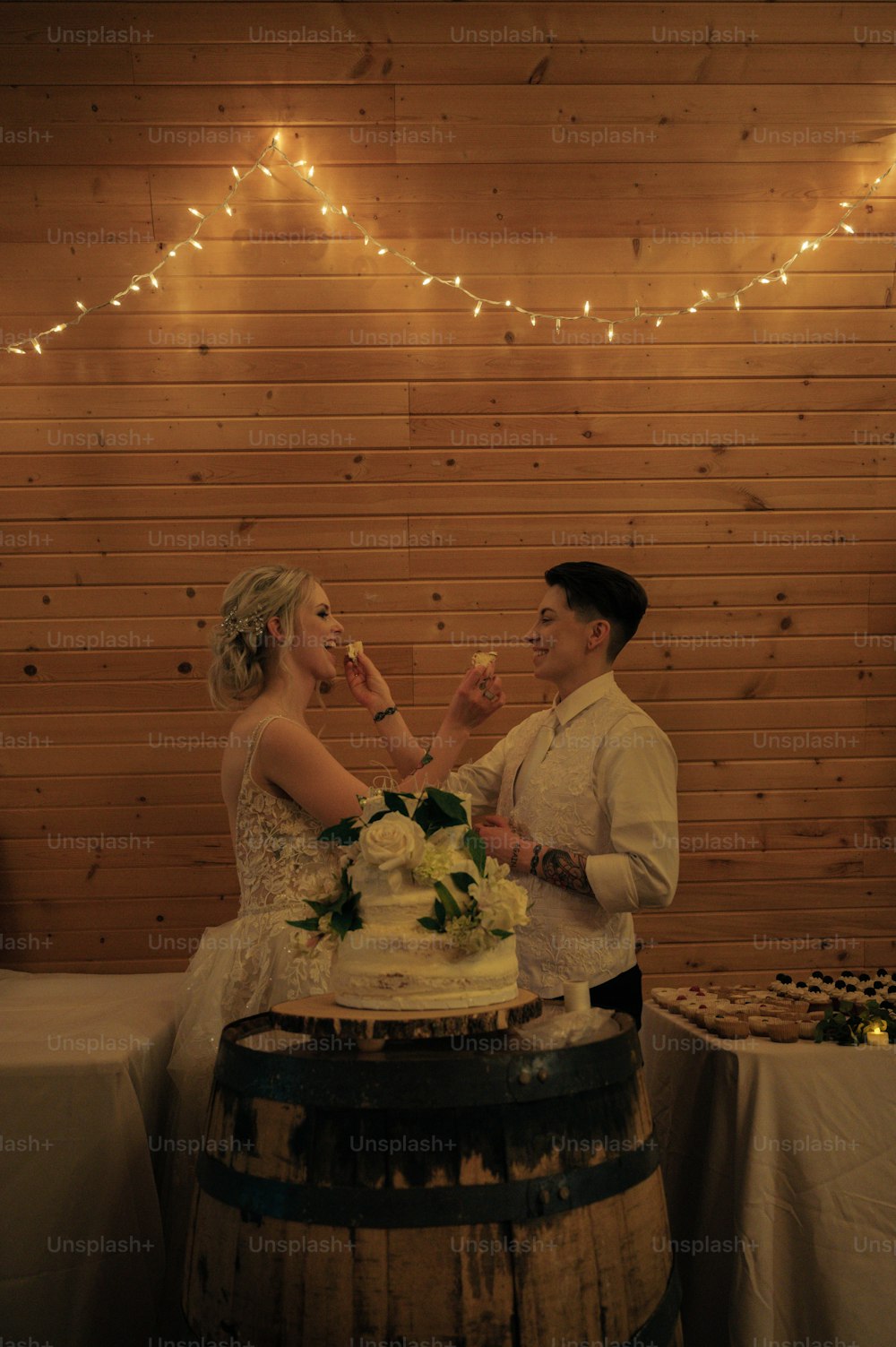 a bride and groom feeding each other a piece of cake