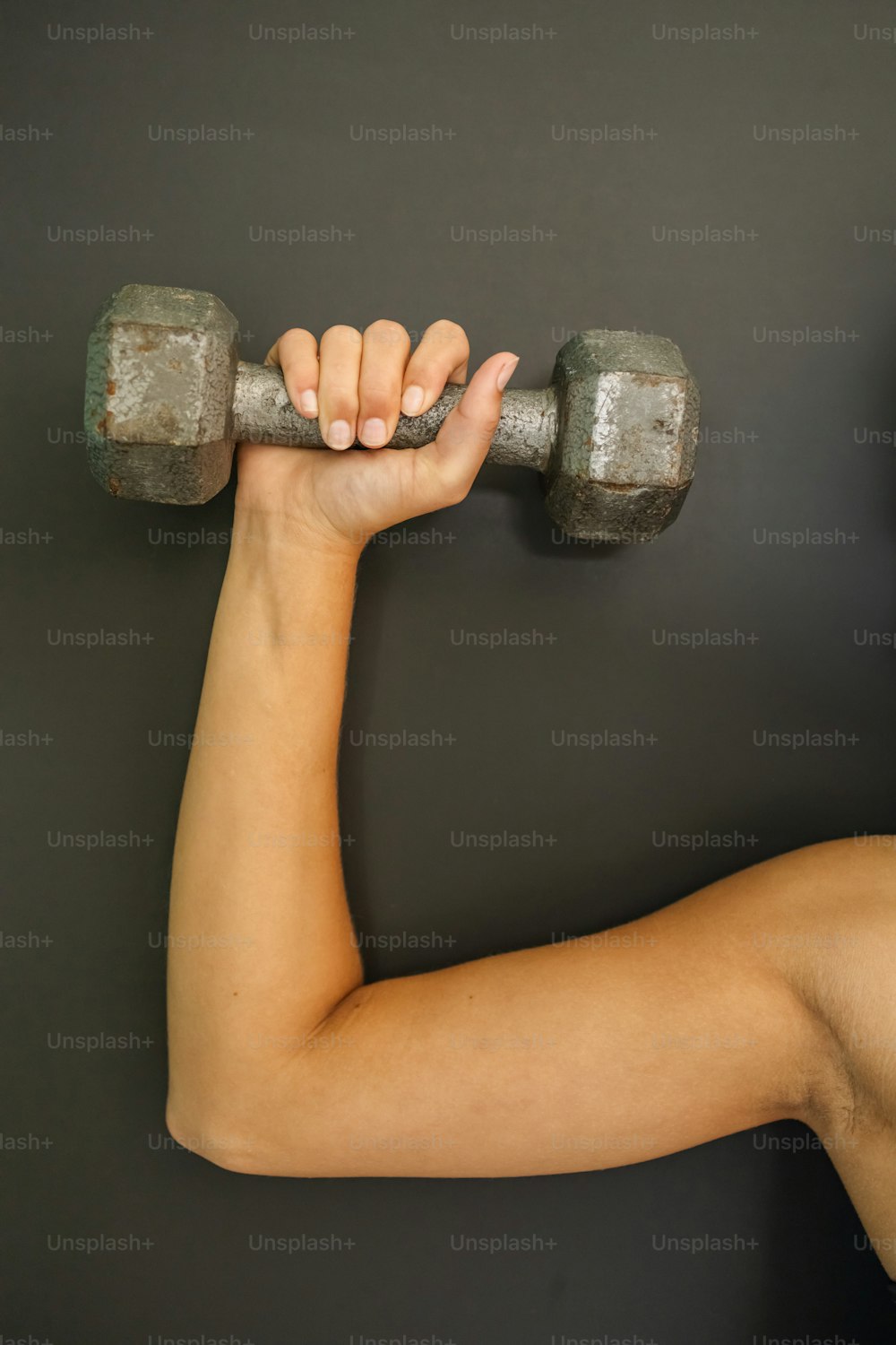 a woman holding two dumbs in her hands