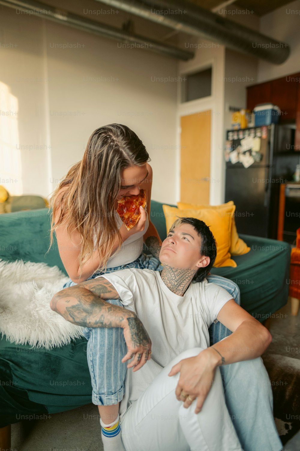 a woman sitting on a man's lap in a living room