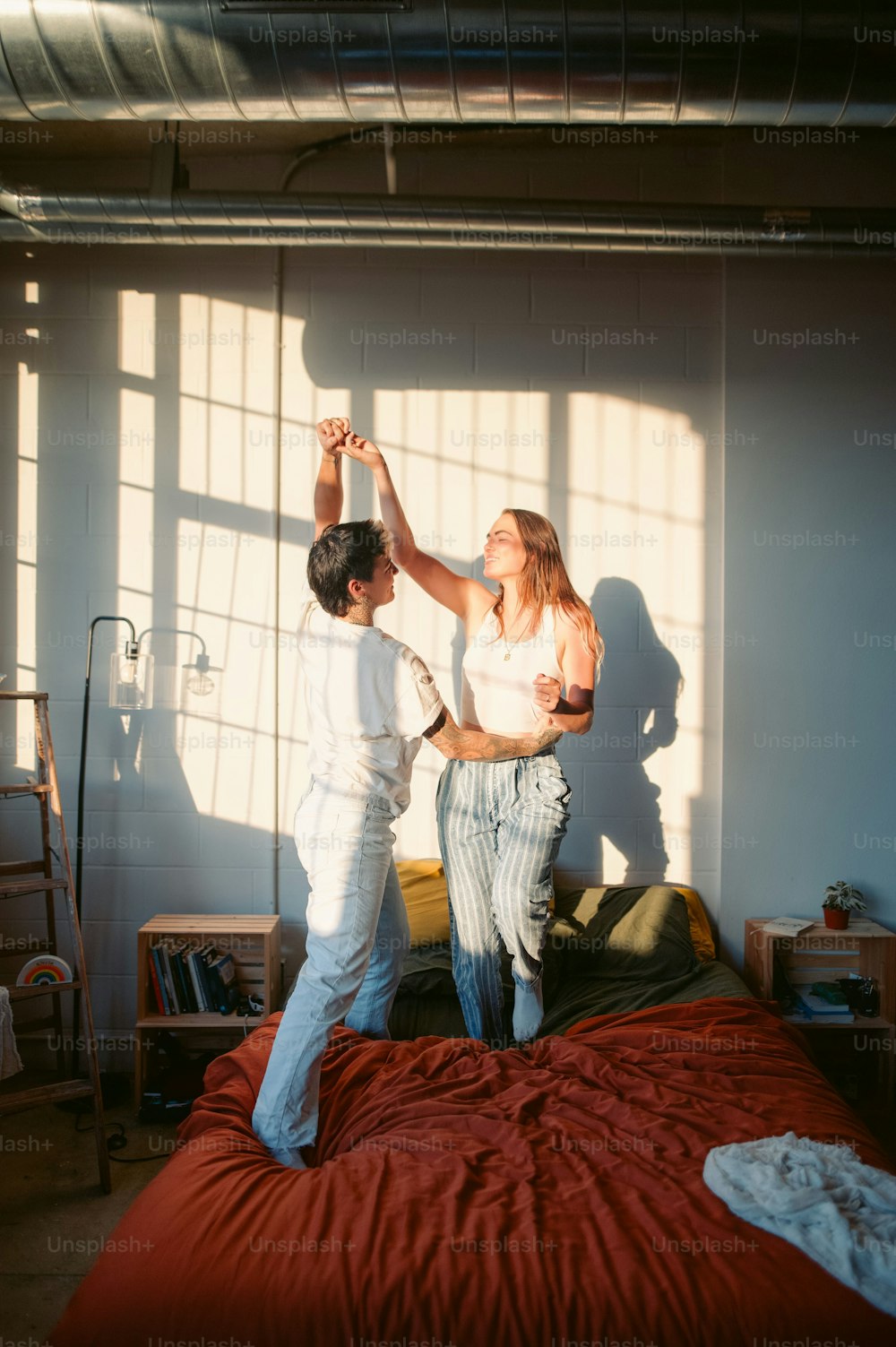 a man and a woman dancing on a bed