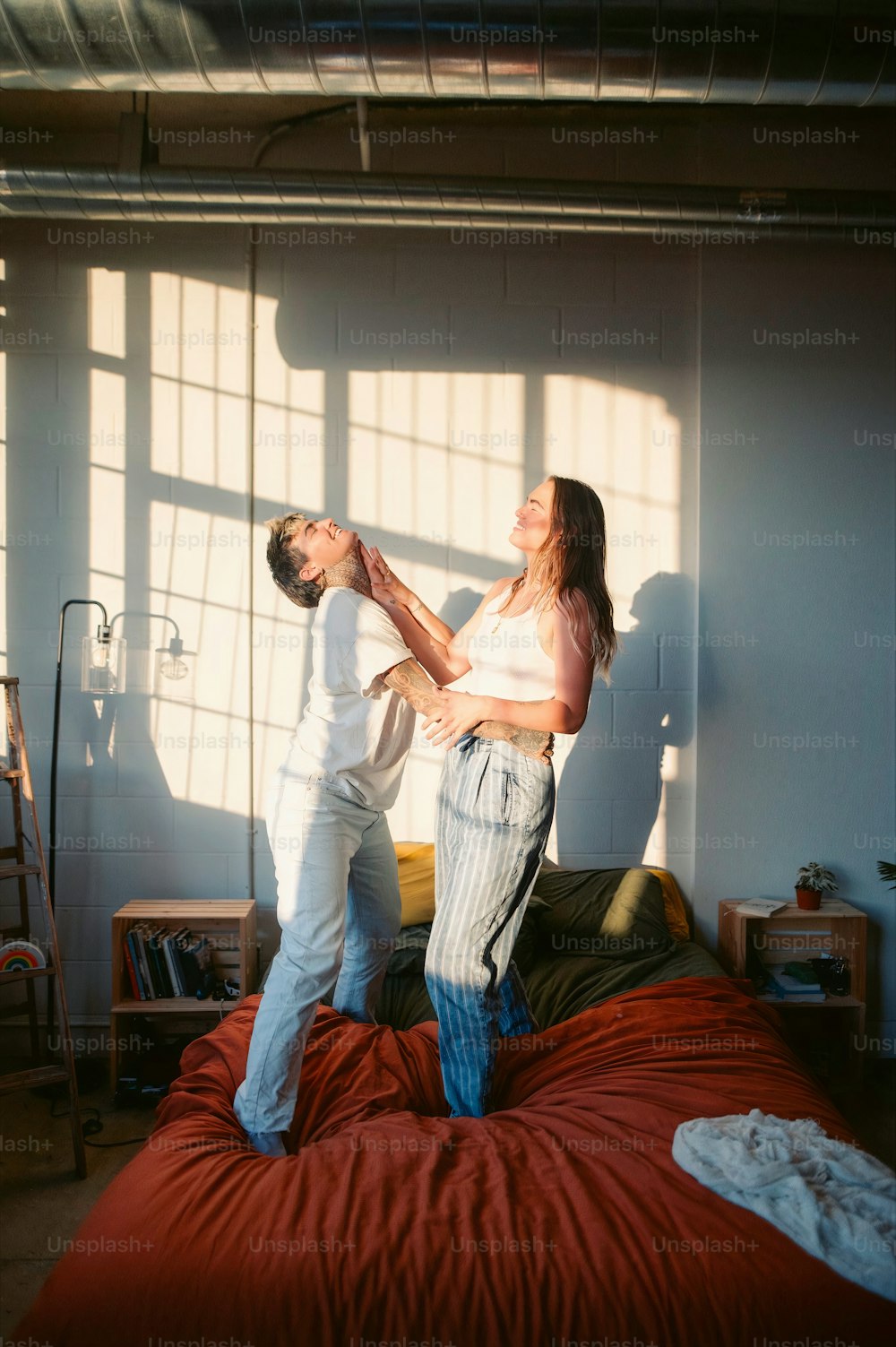 a man and a woman standing on a bed