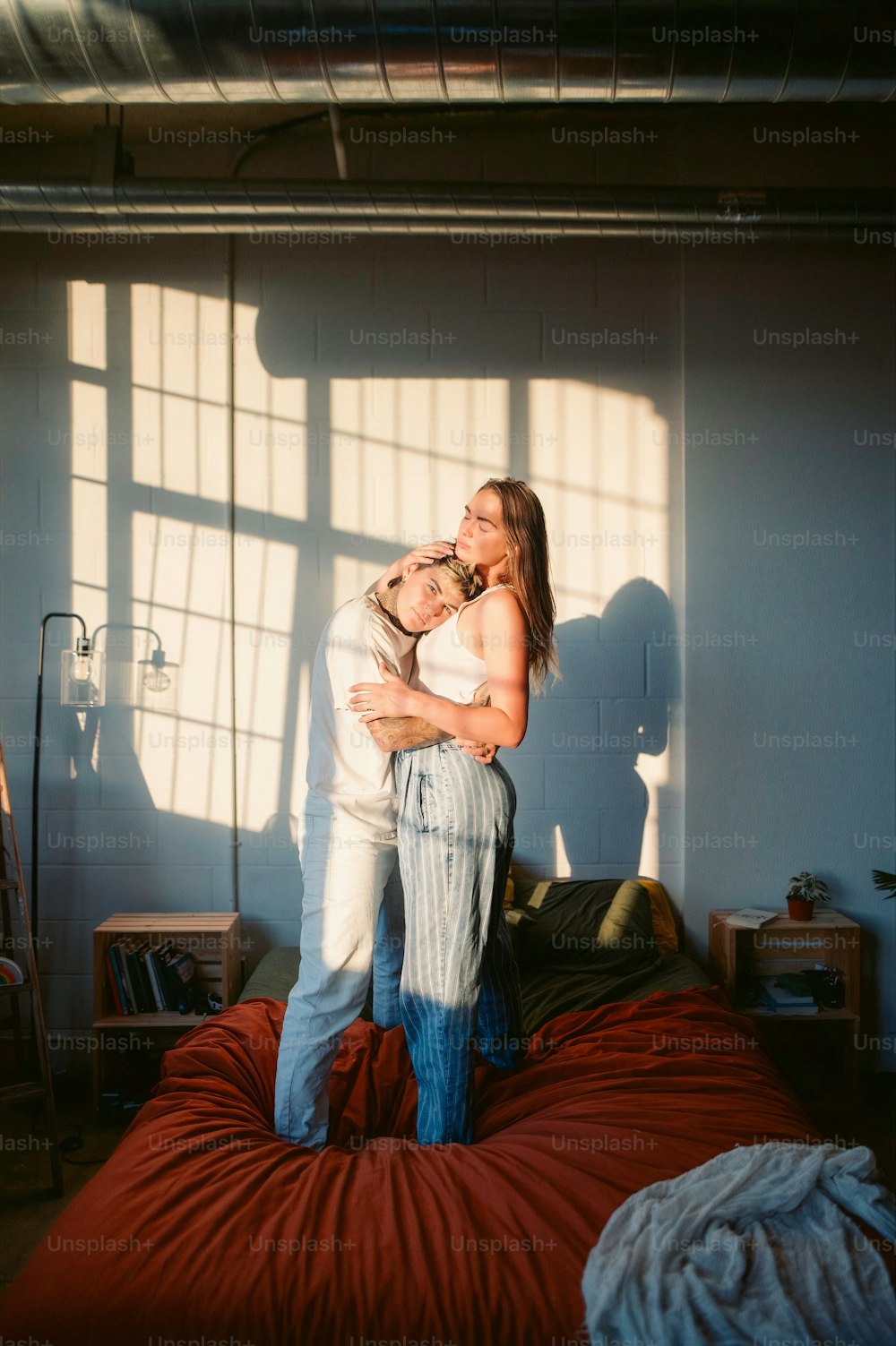 Un hombre y una mujer abrazándose en un dormitorio