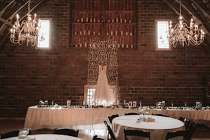 a room with tables and chandeliers in it