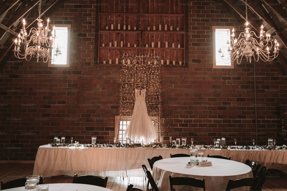 a room with tables and chandeliers in it