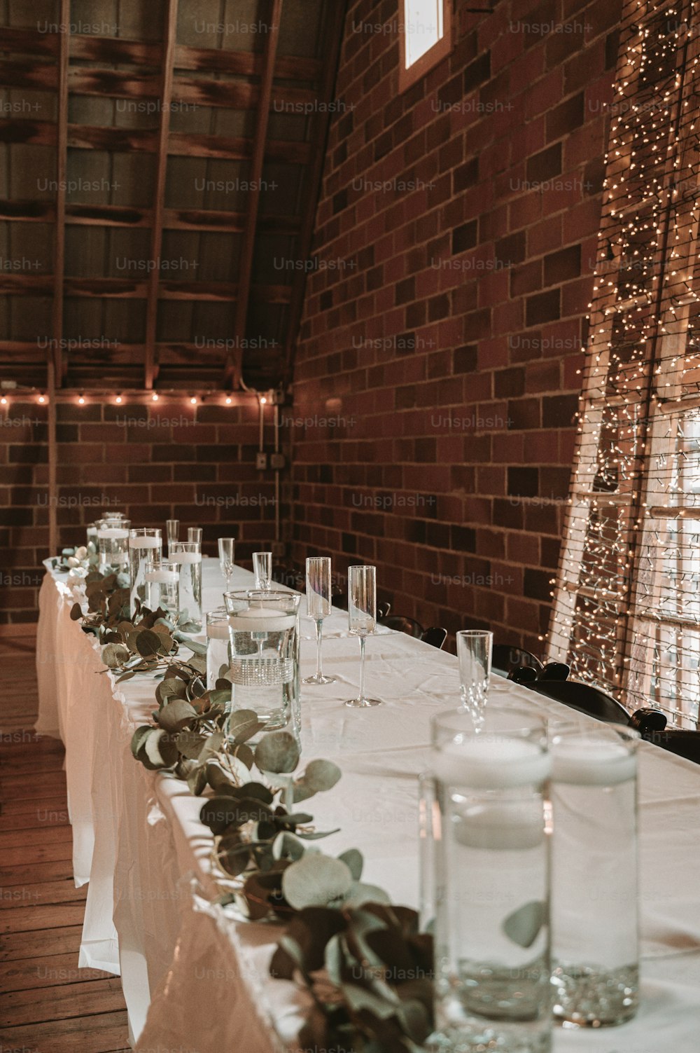 a long table is set up with candles and place settings