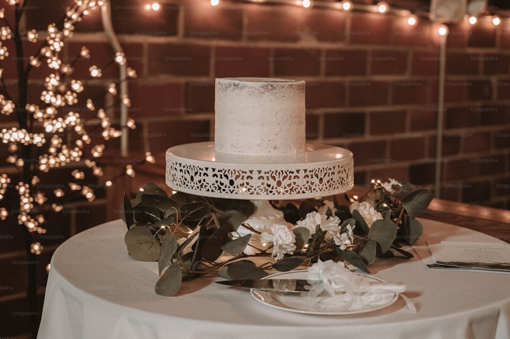 a white wedding cake on top of a table