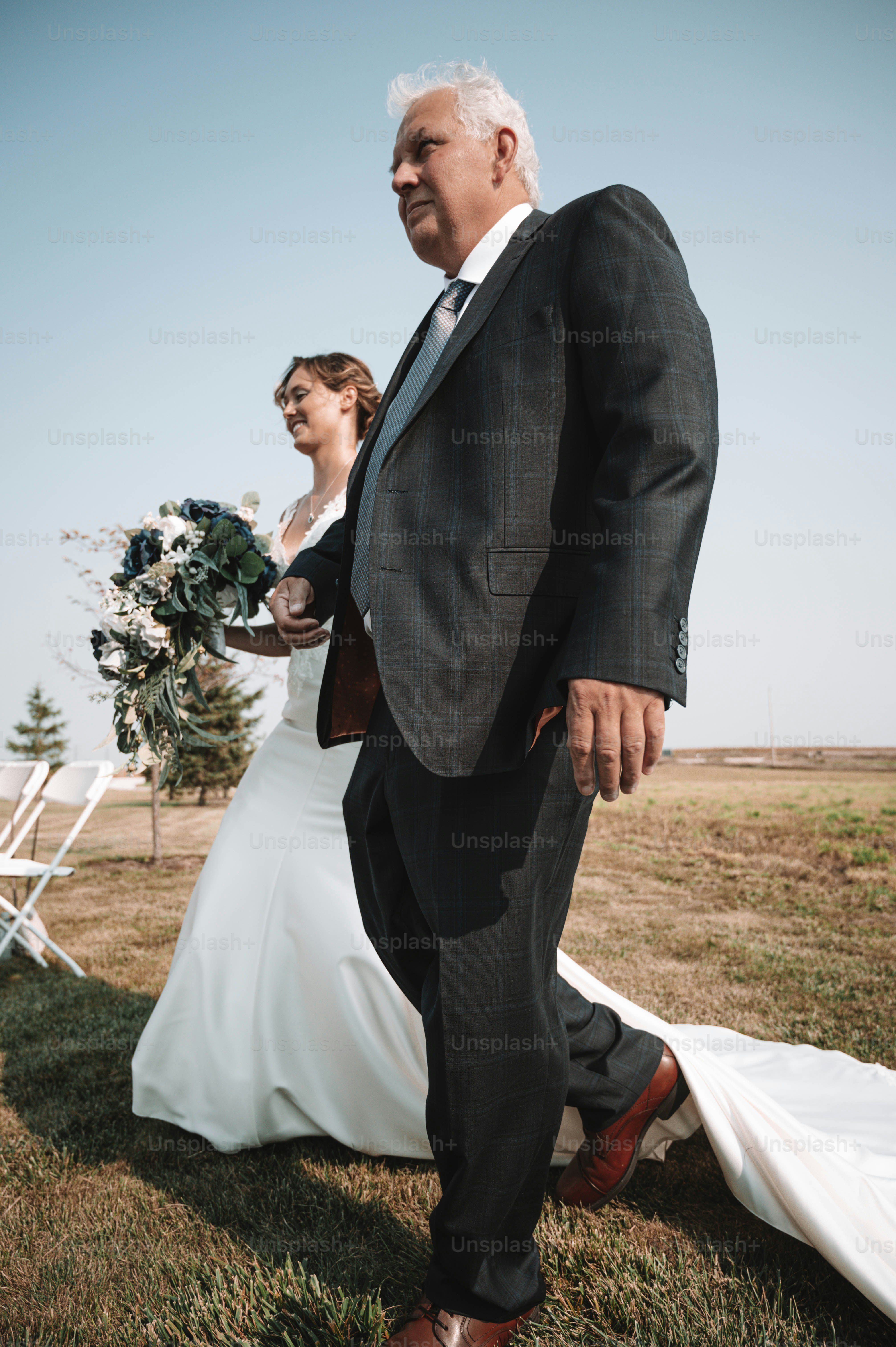 a man in a suit and tie walking with a woman