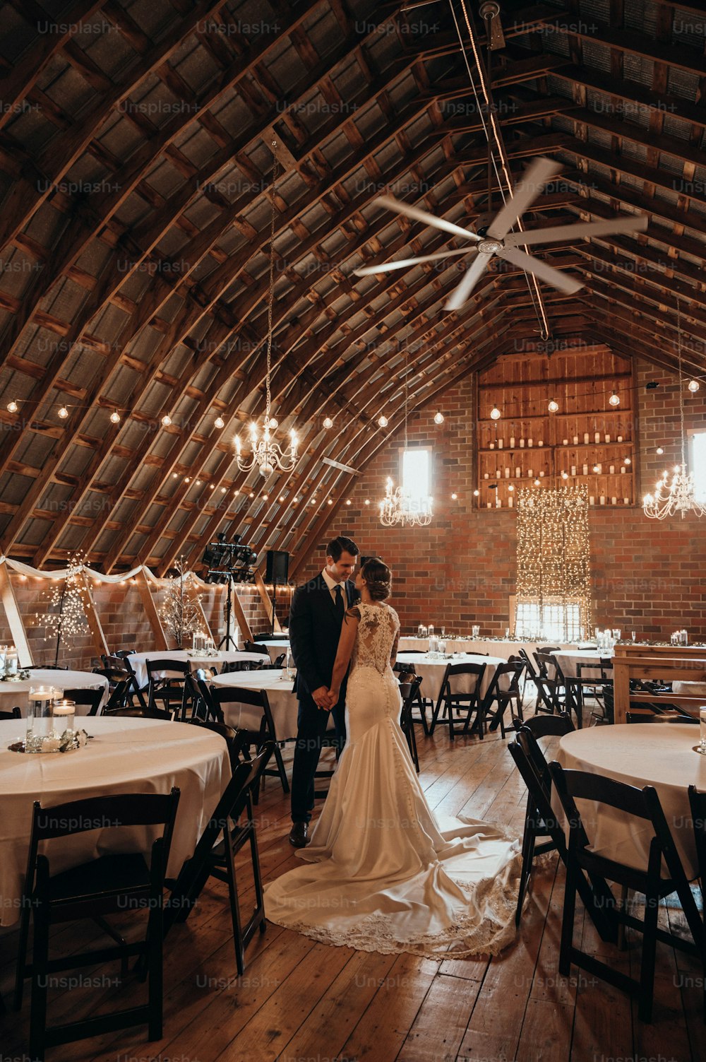 a bride and groom standing in a large room