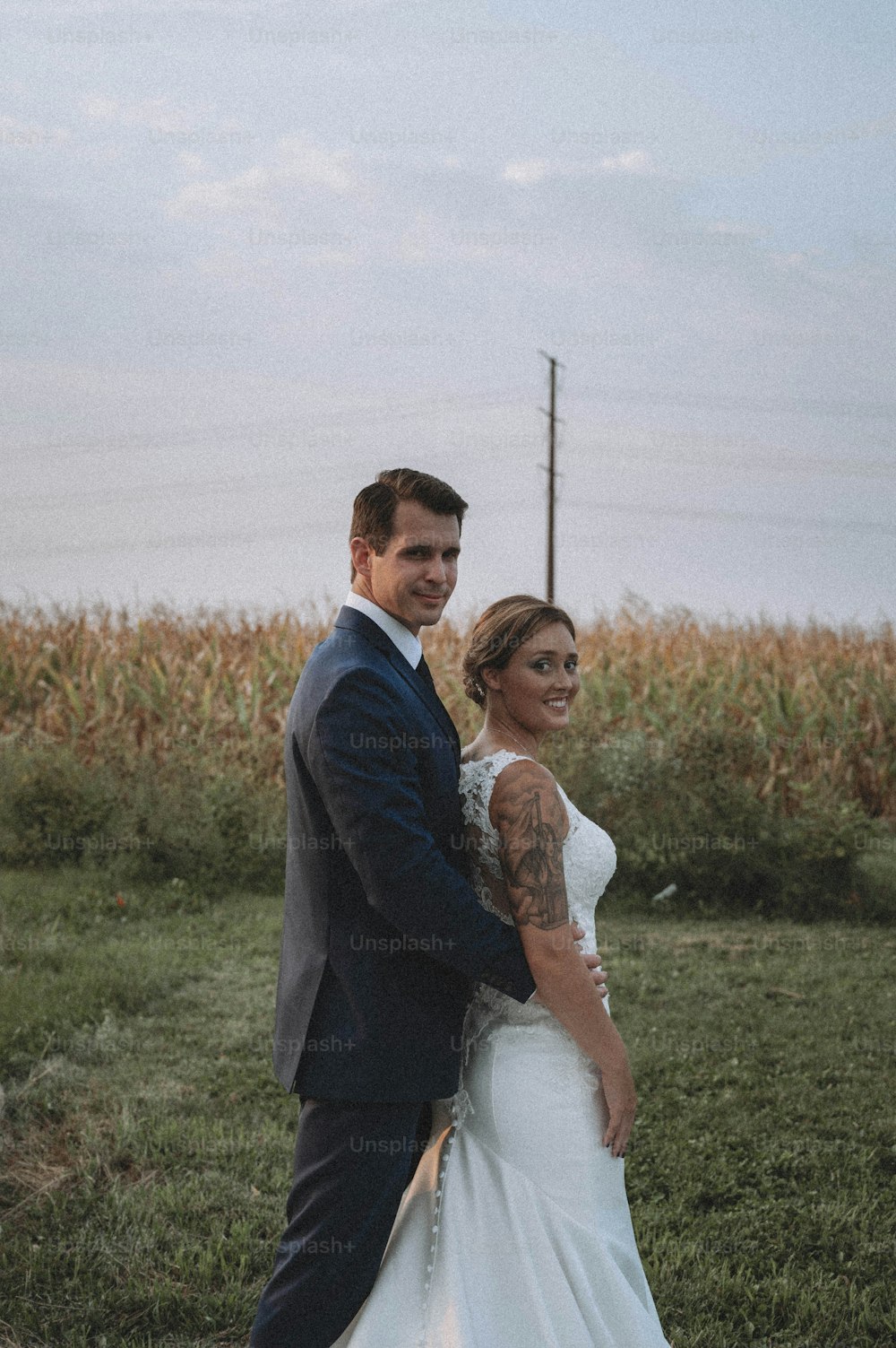 a man and a woman standing in a field